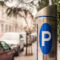 Automatic ticket machine parking on a city street with blurred cars. Blue sign of parking cars.